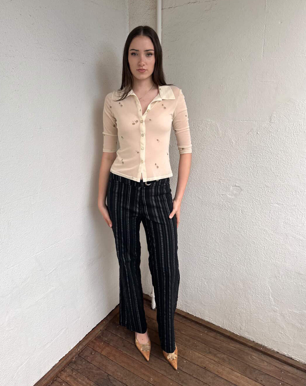 Women wearing a 00s Y2K Gorgeous 90s Cream floral mesh shirt with a cropped fit and 3/4 sleeves. 