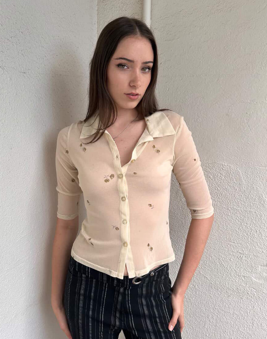 Women wearing a 00s Y2K Gorgeous 90s Cream floral mesh shirt with a cropped fit and 3/4 sleeves. 