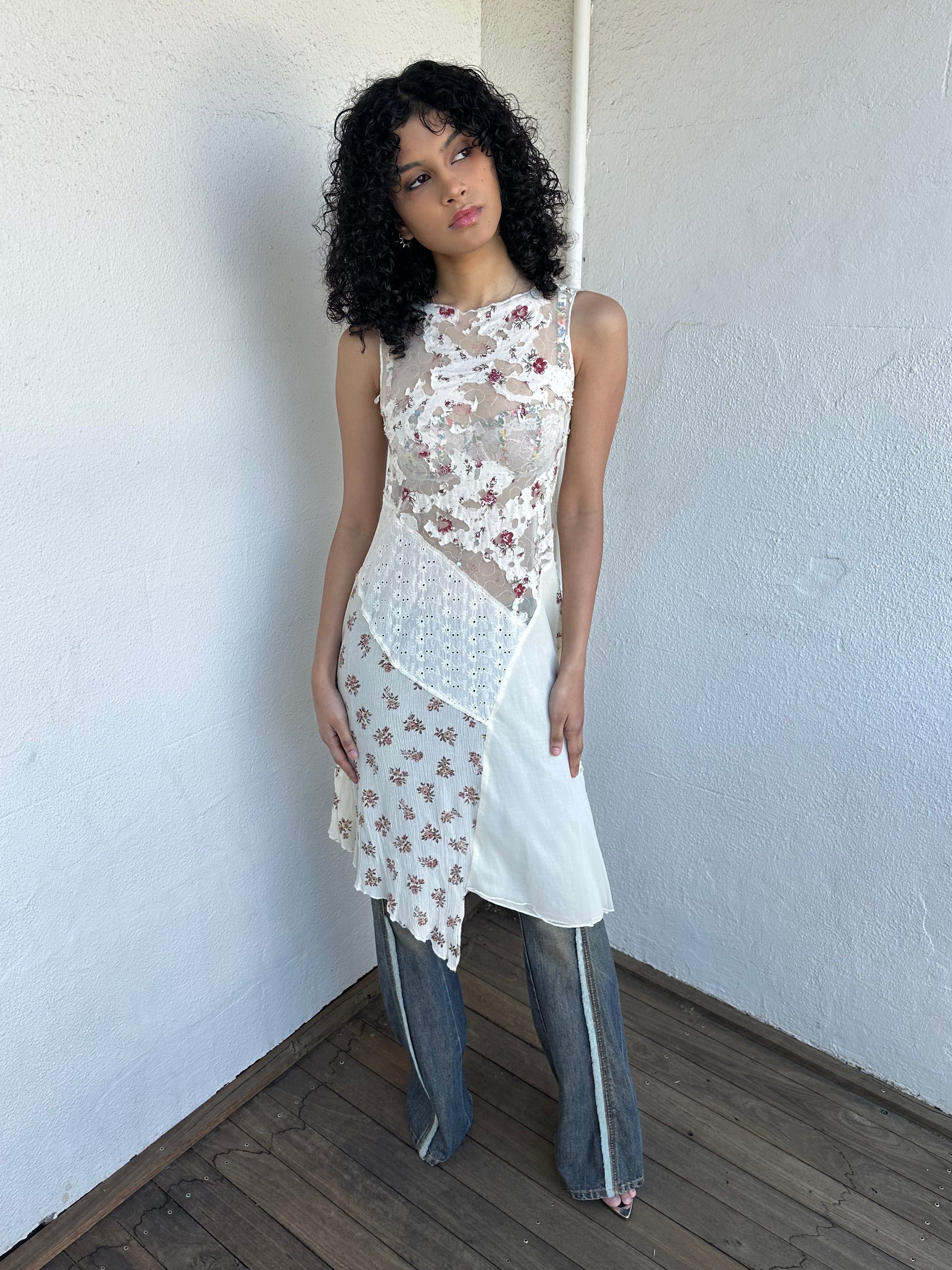 Woman wearing a Y2K 00s Cream lace midi dress with a pink floral pattern and a mix of sheer and non-sheer lace panels