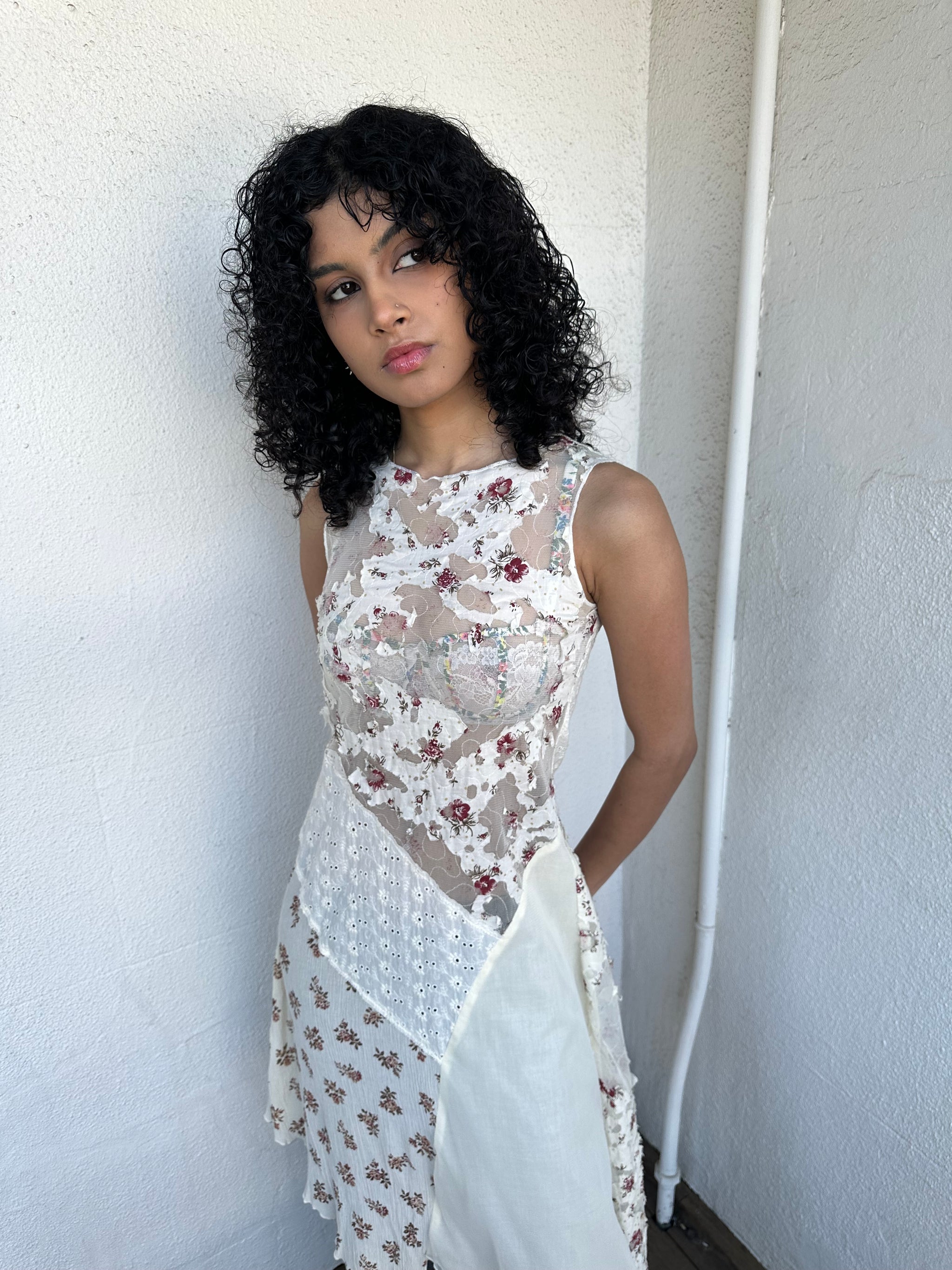 Woman wearing a Y2K 00s Cream lace midi dress with a pink floral pattern and a mix of sheer and non-sheer lace panels