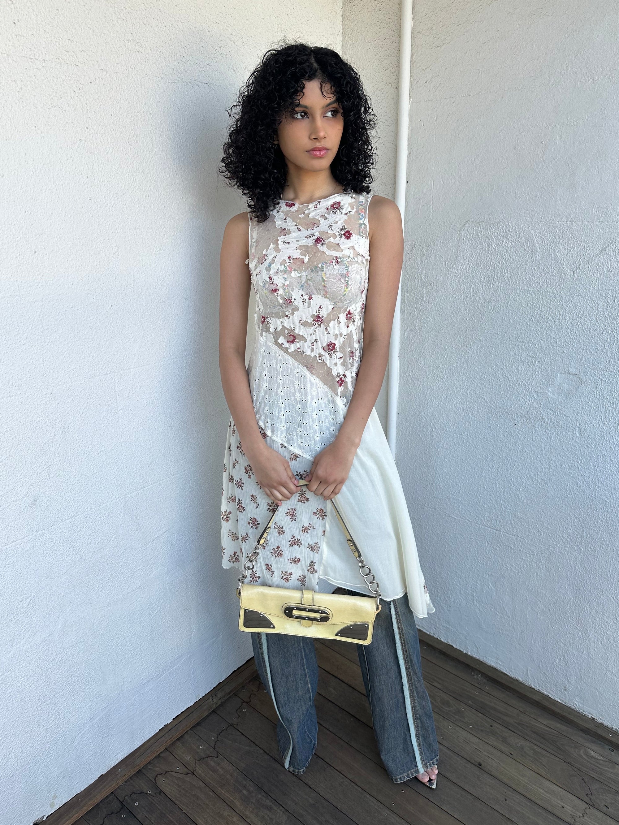 Woman wearing a Y2K 00s Cream lace midi dress with a pink floral pattern and a mix of sheer and non-sheer lace panels