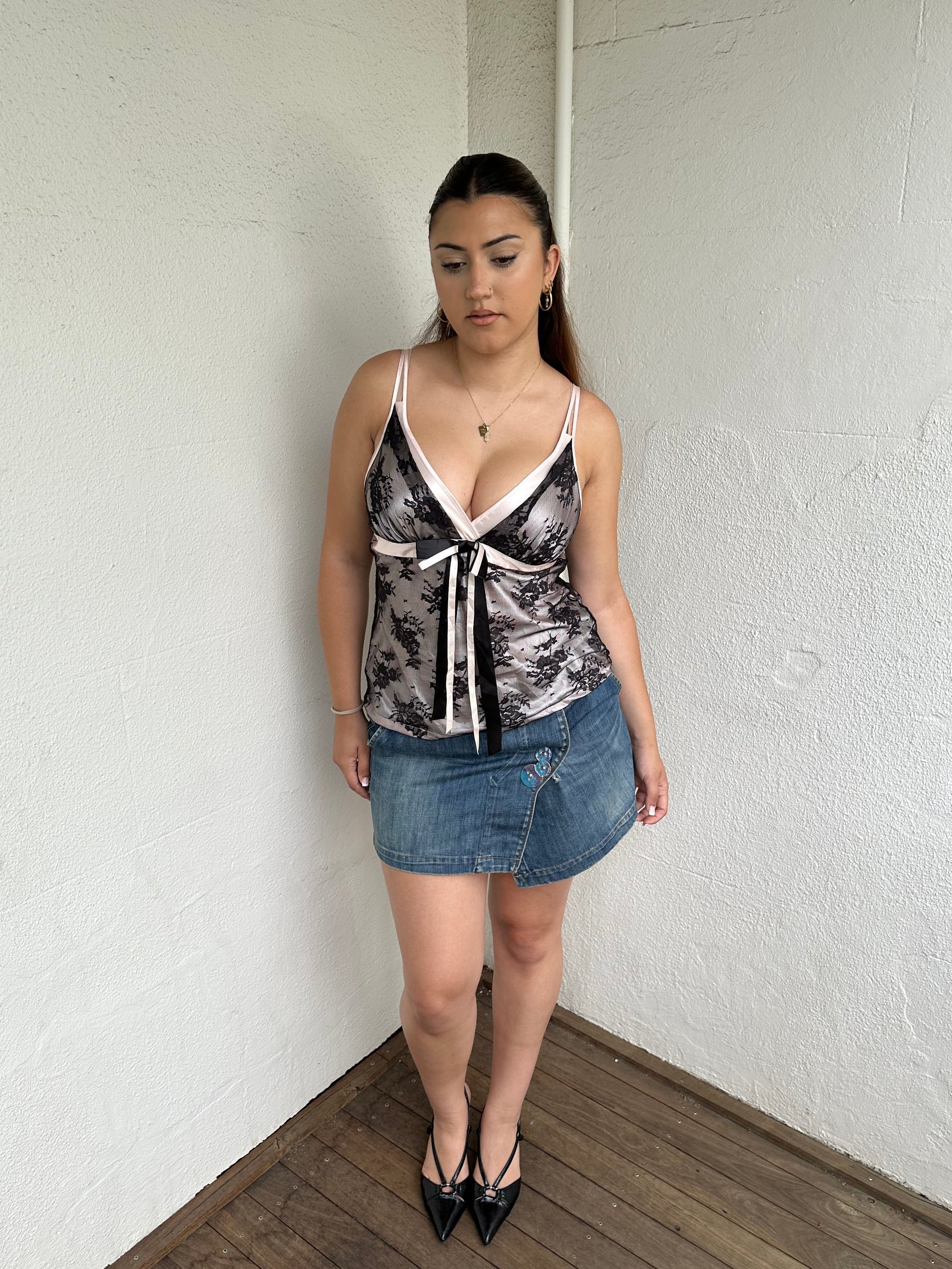 Woman Dressed in Y2K Denim button front wrap mini skirt featuring a classic blue denim finish 