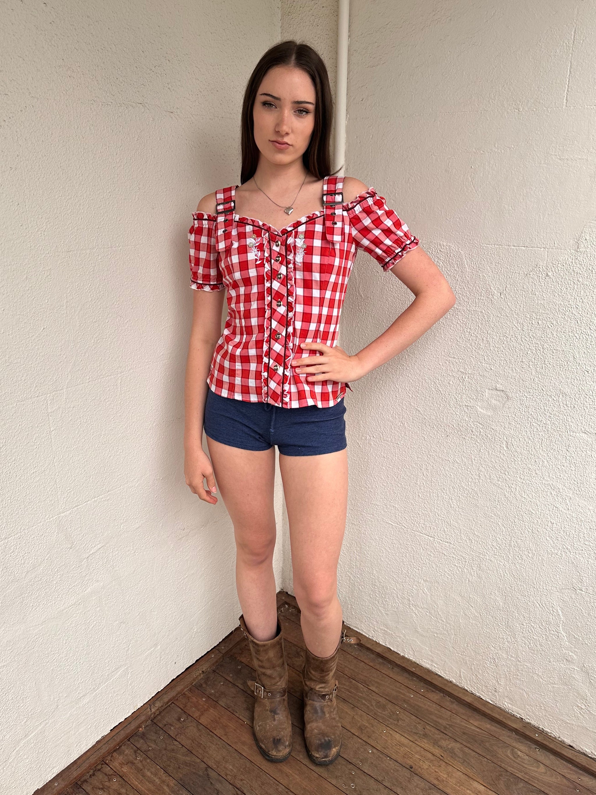 Woman wearing a Y2K 00s Denim look booty shorts feature bold red stitch detailing perfect for a festival 