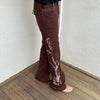 Woman Dressed in Y2K 00s Embroidery detail brown Y2K cargo pants featuring a rich brown tone with white floral leaf embroidery