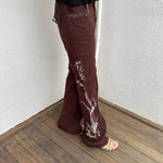 Woman Dressed in Y2K 00s Embroidery detail brown Y2K cargo pants featuring a rich brown tone with white floral leaf embroidery