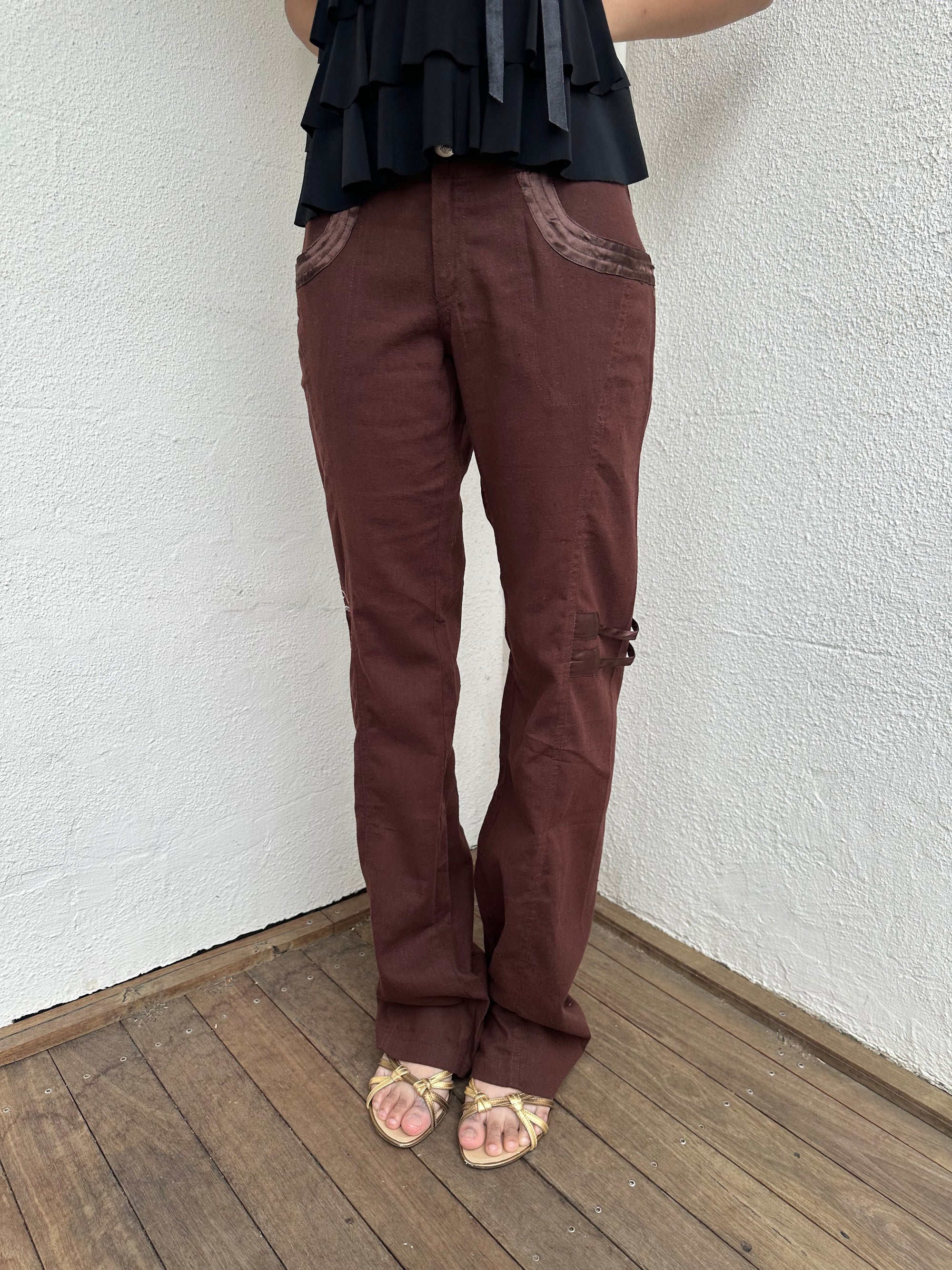 Woman Dressed in Y2K 00s Embroidery detail brown Y2K cargo pants featuring a rich brown tone with white floral leaf embroidery
