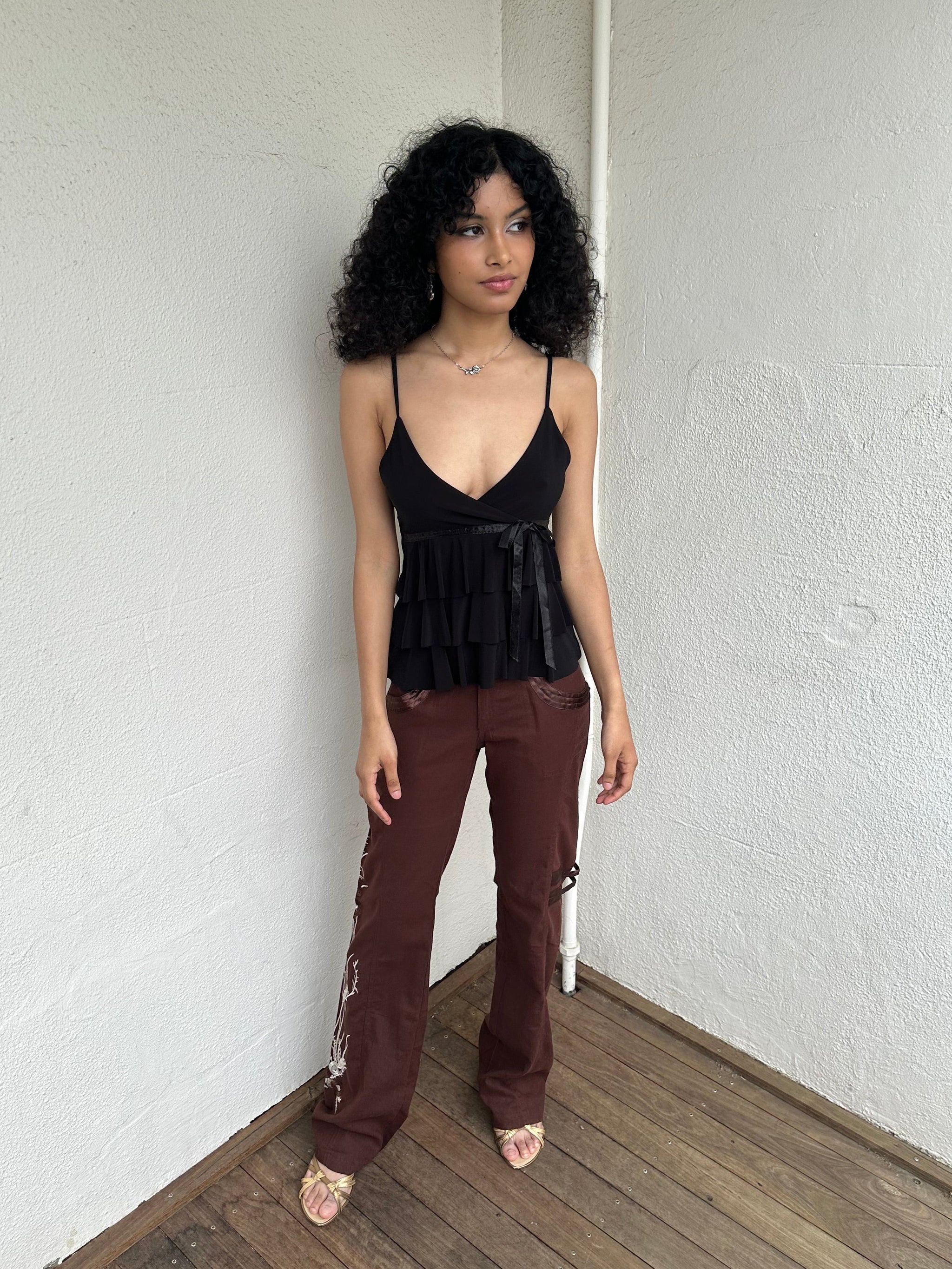 Woman Dressed in Y2K 00s Embroidery detail brown Y2K cargo pants featuring a rich brown tone with white floral leaf embroidery
