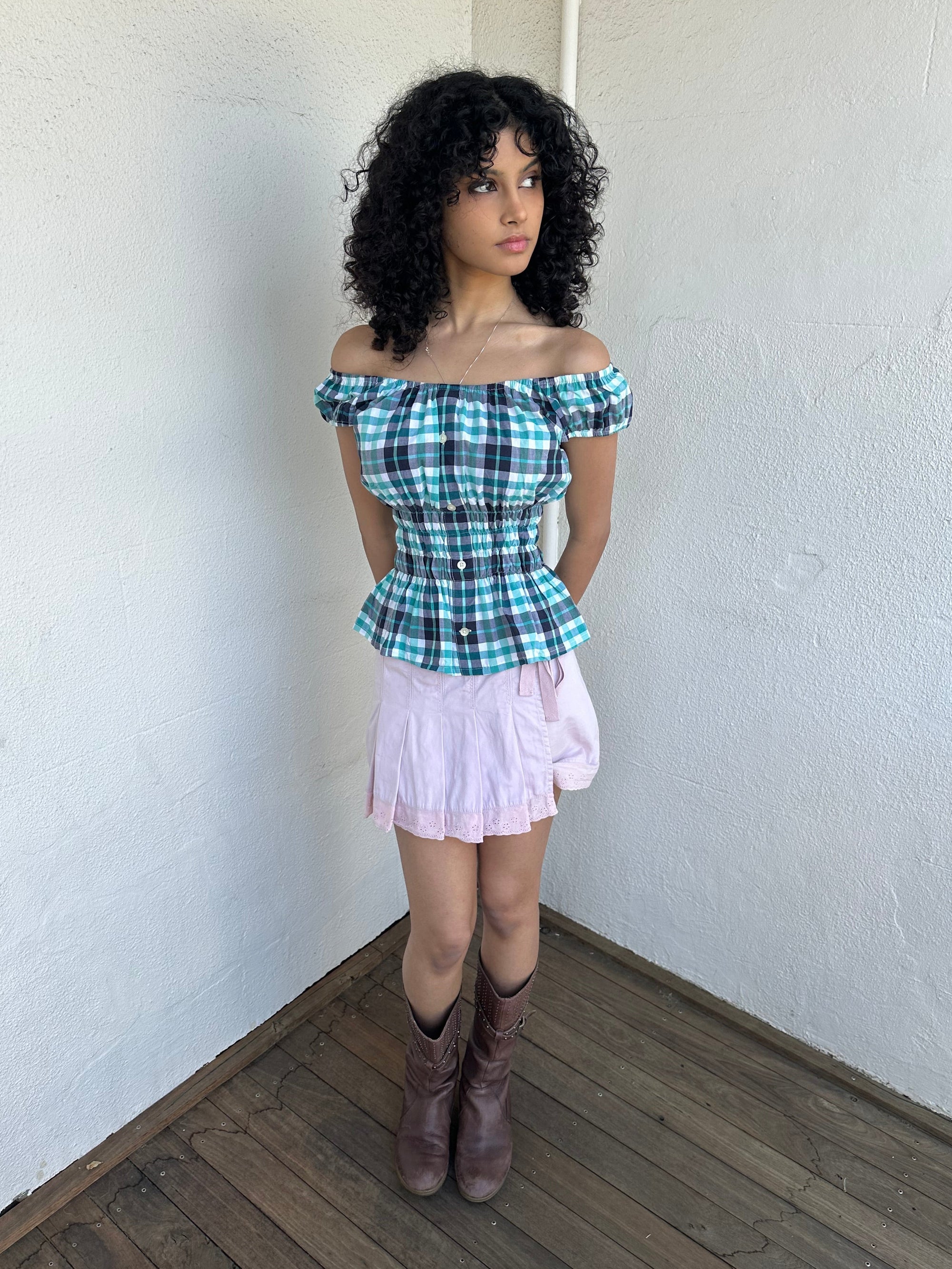 Woman wearing a Y2K 90s reworked vintage shirt transformed into a summer classic green and blue check milkmaid style top