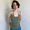 Woman Dressed in Y2K Green and blue layered knitted top featuring a two-toned blue and green ribbed knit.