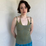 Woman Dressed in Y2K Green and blue layered knitted top featuring a two-toned blue and green ribbed knit.
