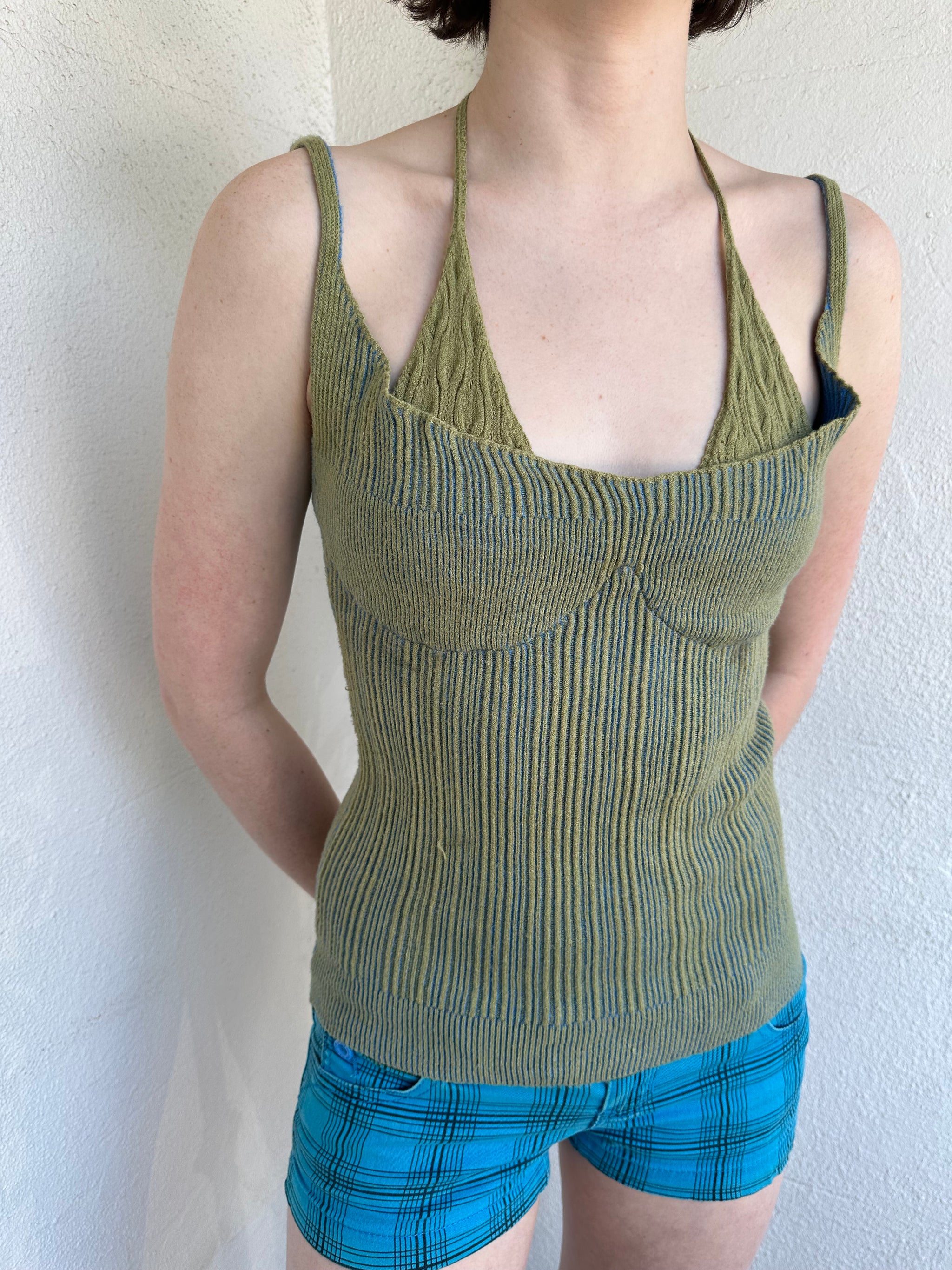 Woman Dressed in Y2K Green and blue layered knitted top featuring a two-toned blue and green ribbed knit.