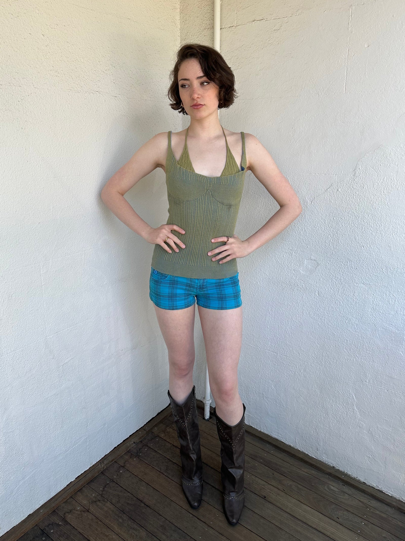 Woman Dressed in Y2K Green and blue layered knitted top featuring a two-toned blue and green ribbed knit.