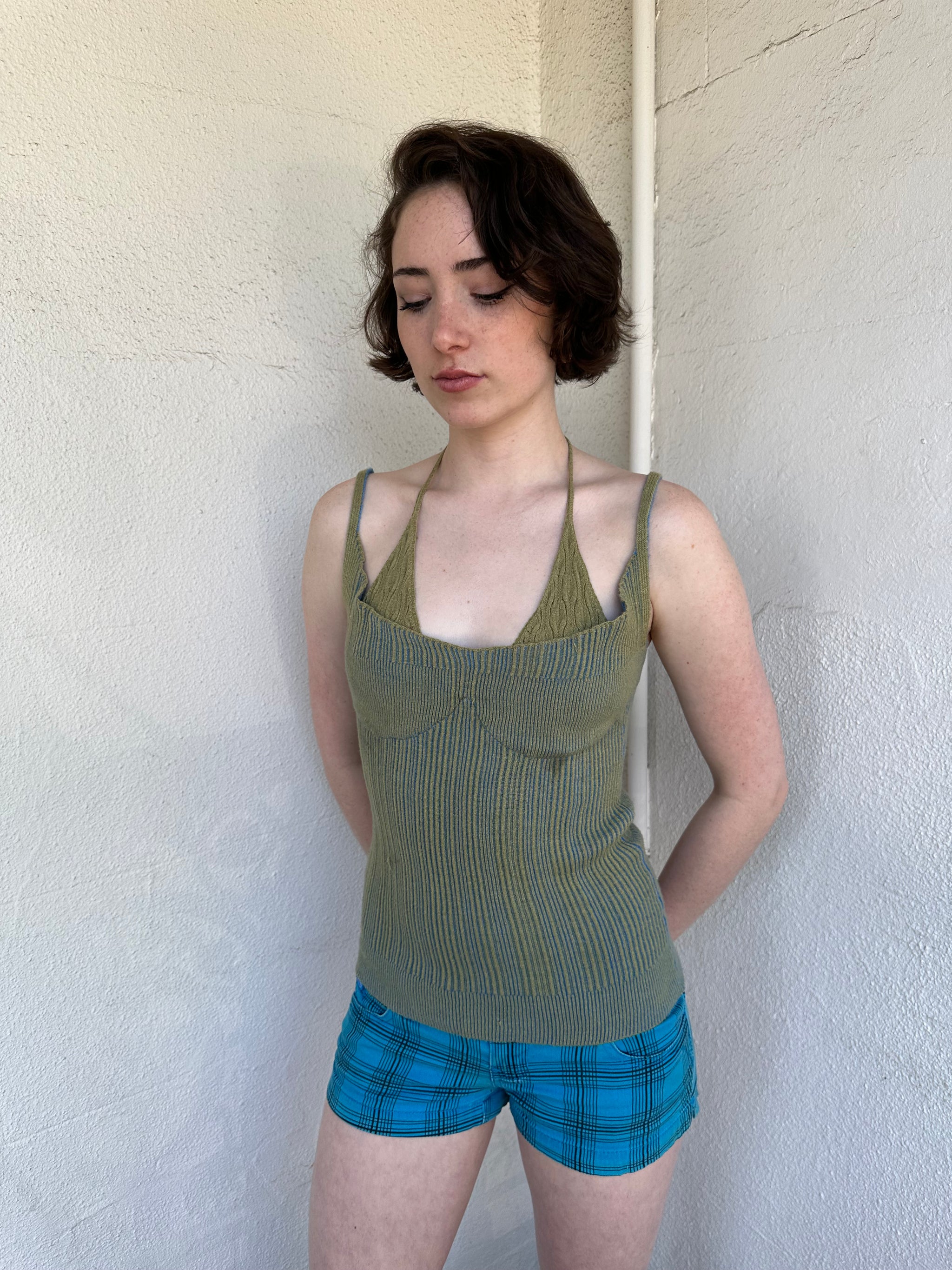 Woman Dressed in Y2K Green and blue layered knitted top featuring a two-toned blue and green ribbed knit.