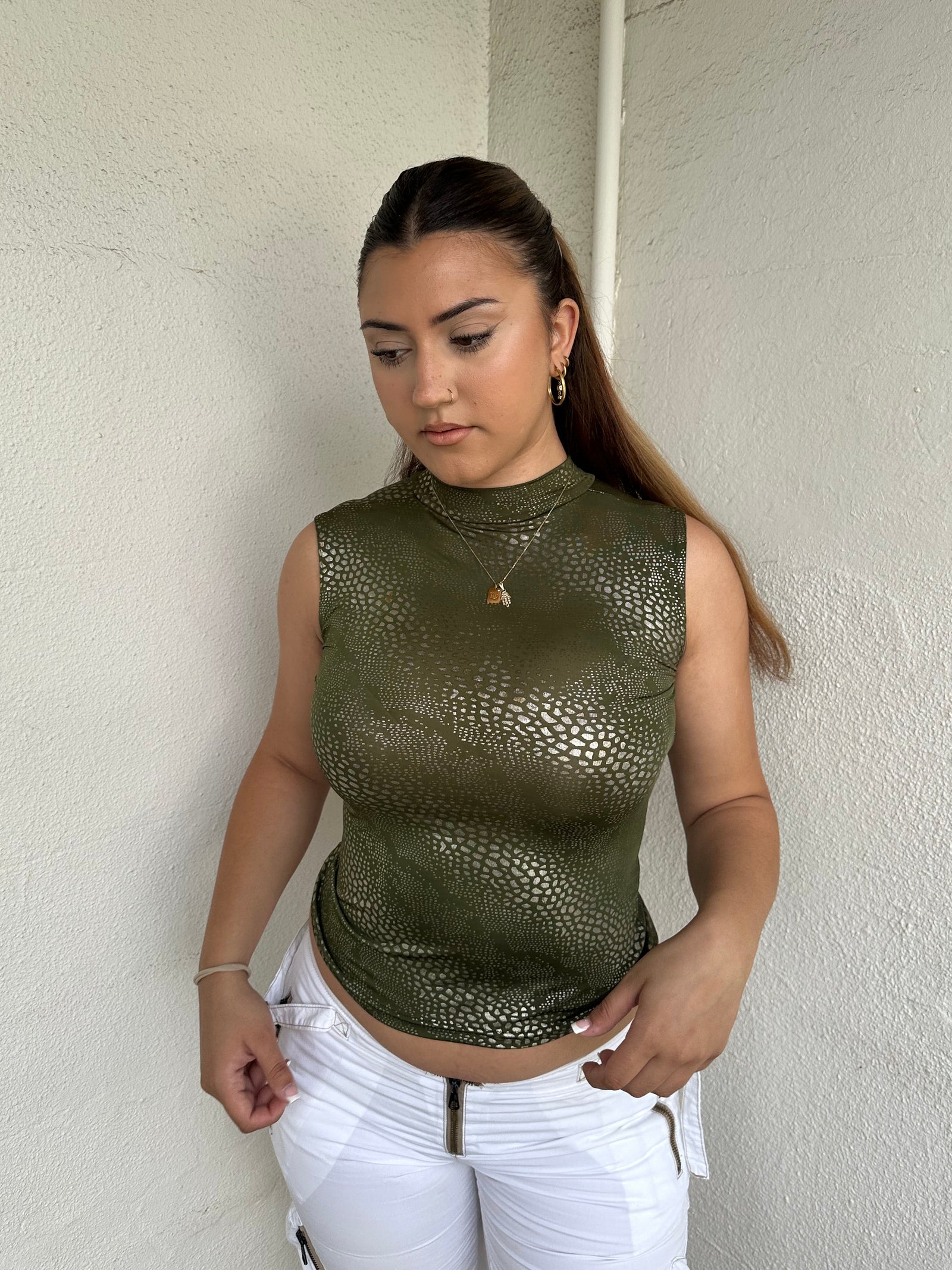 Woman Dressed in Y2K 00s Green and silver snake print tank top featuring a shimmering snake print throughout.