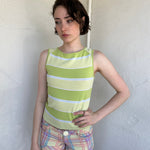 Woman Dressed in Y2K Green stripe knitted tank top featuring alternating horizontal stripes in pastel green and lime green 