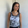 Woman Dressed in Y2K 00s Grey graphic tank top featuring a grey base with white and black graphic print on the front.
