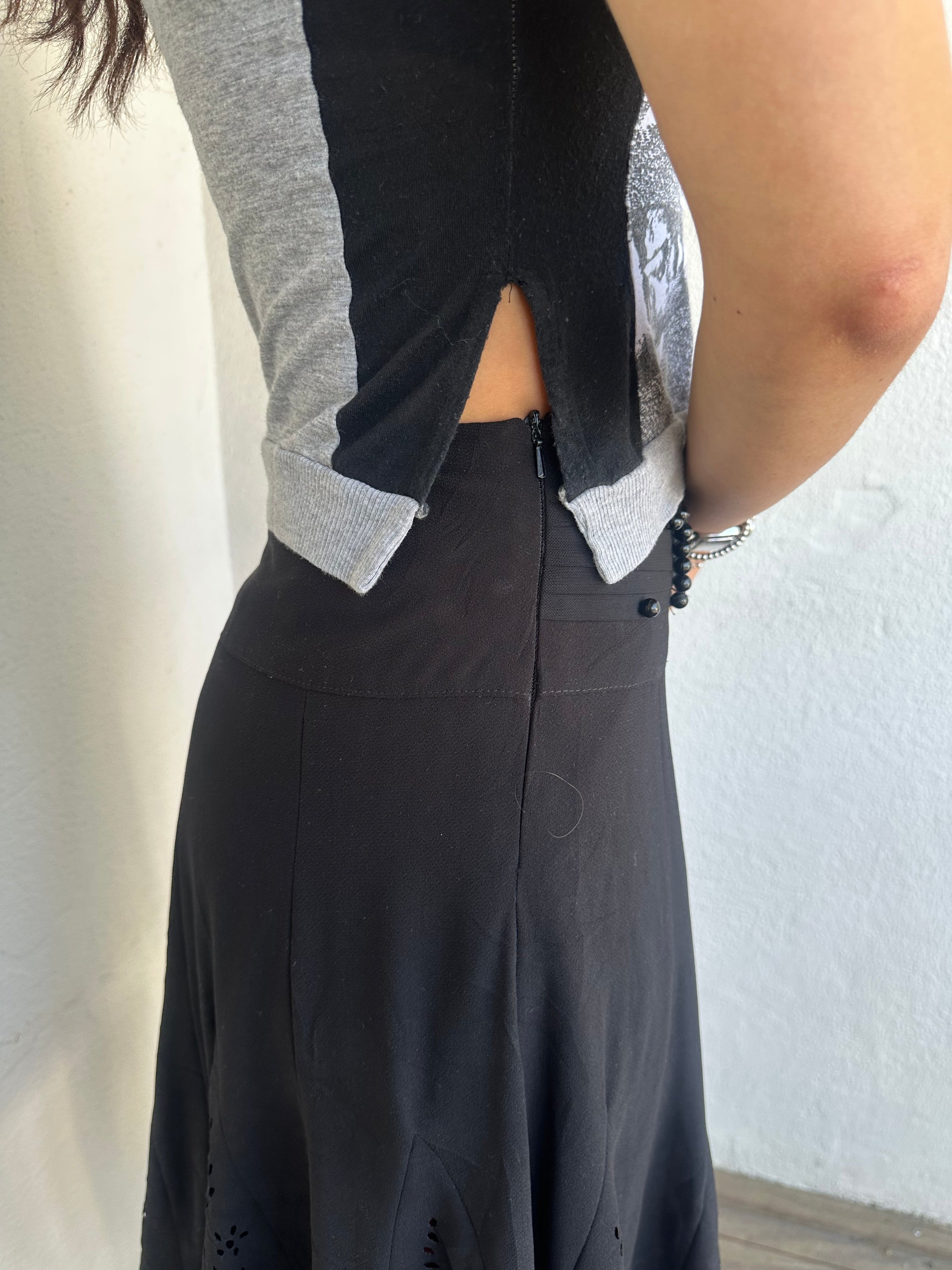 Woman Dressed in Y2K 00s Grey graphic tank top featuring a grey base with white and black graphic print on the front.
