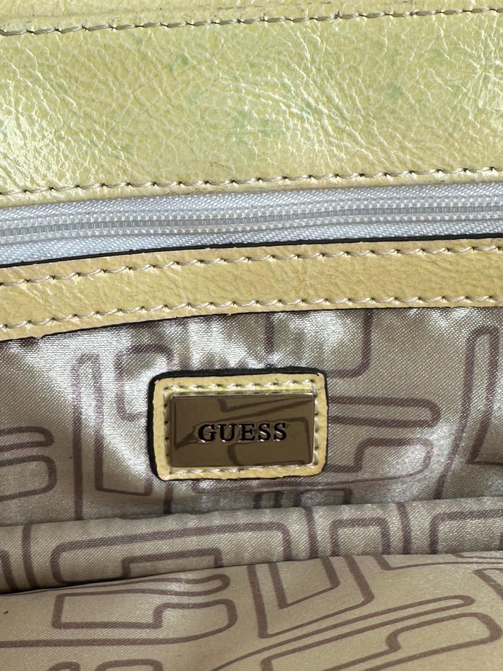 Women wearing a 00s Y2K Guess pastel yellow mini shoulder bag from the 2000s crafted from faux leather in a small rectangular shape.