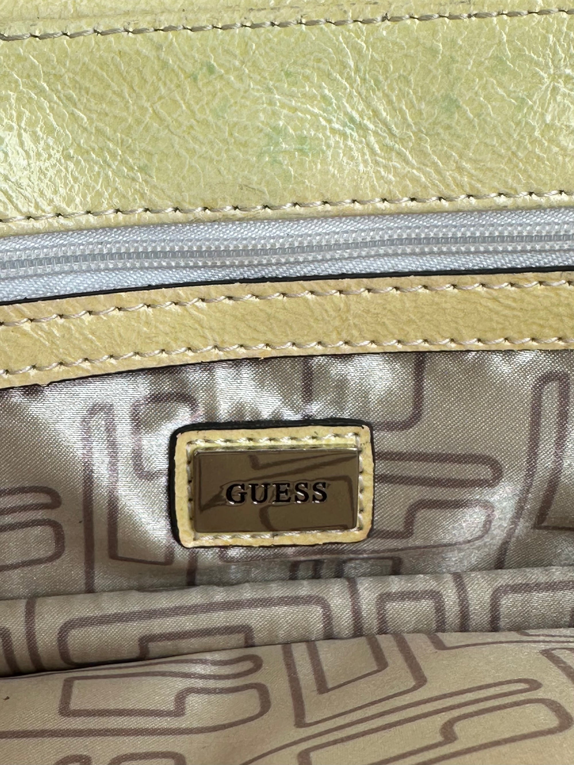 Women wearing a 00s Y2K Guess pastel yellow mini shoulder bag from the 2000s crafted from faux leather in a small rectangular shape.