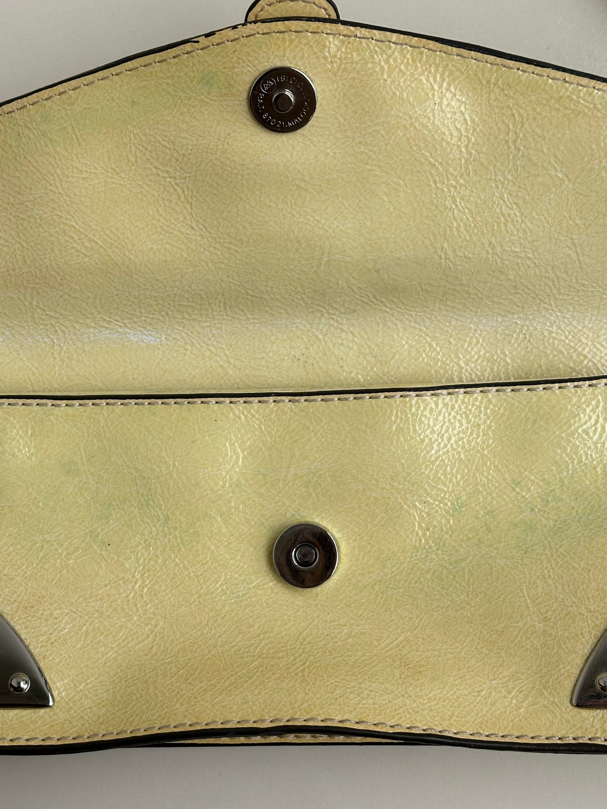 Women wearing a 00s Y2K Guess pastel yellow mini shoulder bag from the 2000s crafted from faux leather in a small rectangular shape.