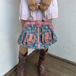 Woman wearing a Y2K 00s Guess Denim Monogram Satchel Bag