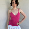 Woman Dressed in Y2K Hot pink and baby pink polkadot cami top featuring small white polkadots throughout a vibrant hot pink base.