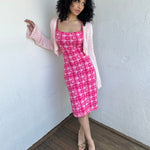 Woman wearing a Y2K 00s Hot pink groovy-style dress covered in bold white & baby pink polkadots.