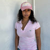 Woman Dressed in Y2K 00s Lacoste baby pink stripe polo with a collared neckline and soft fitted silhouette.