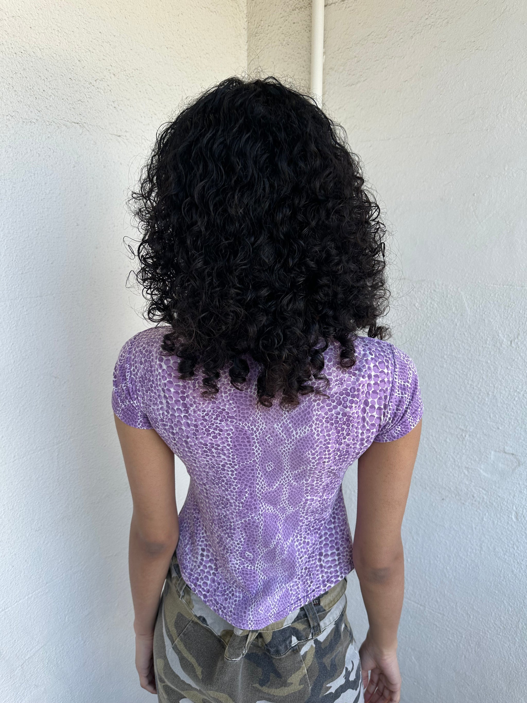 Women wearing a 00s Y2K Lilac snake print t-shirt featuring a keyhole front opening with adjustable tie design.