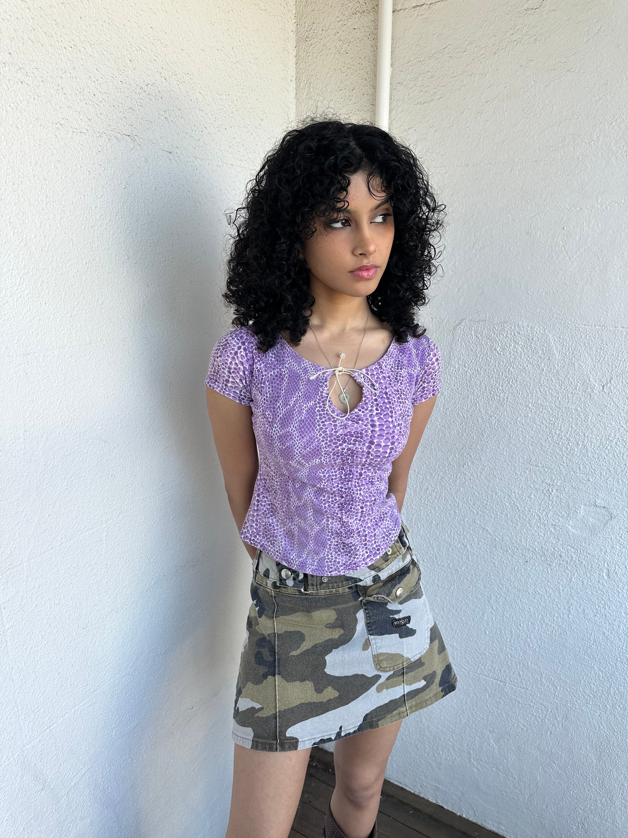 Women wearing a 00s Y2K Lilac snake print t-shirt featuring a keyhole front opening with adjustable tie design.