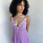 Woman wearing a Y2K 00s Lilac floral embroidered bust cami with a floaty, pleated A-line shape