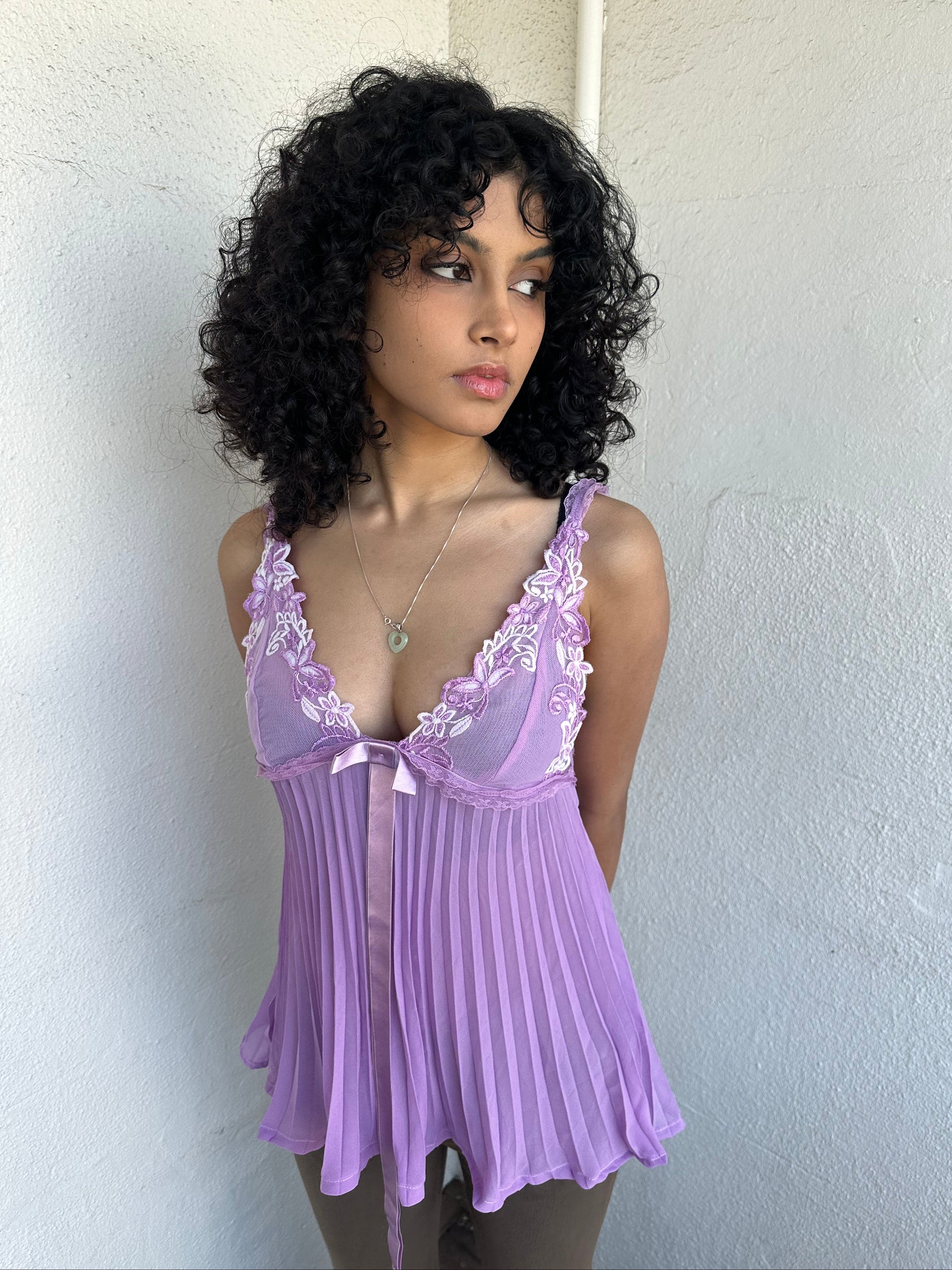 Woman wearing a Y2K 00s Lilac floral embroidered bust cami with a floaty, pleated A-line shape