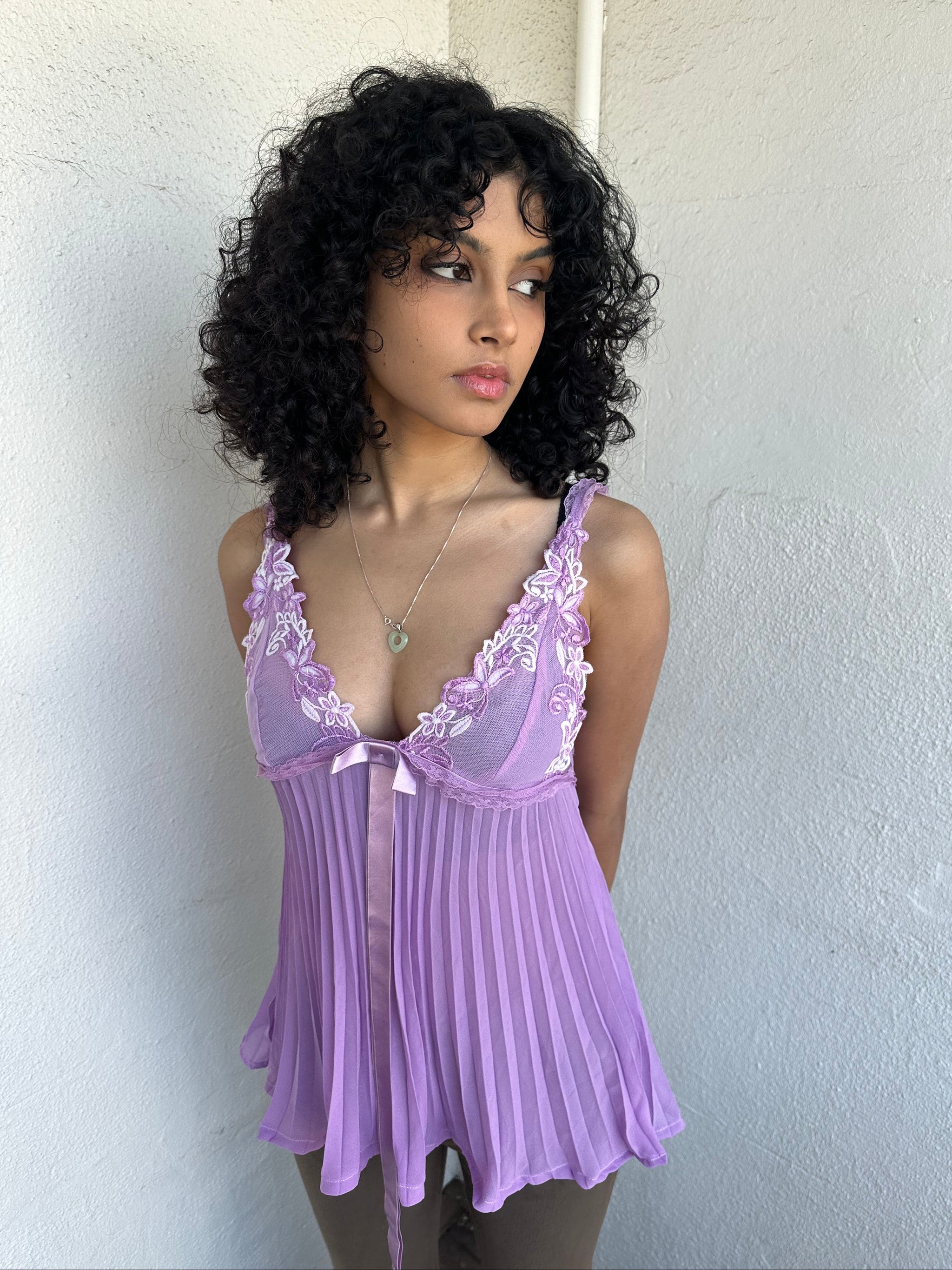 Woman wearing a Y2K 00s Lilac floral embroidered bust cami with a floaty, pleated A-line shape