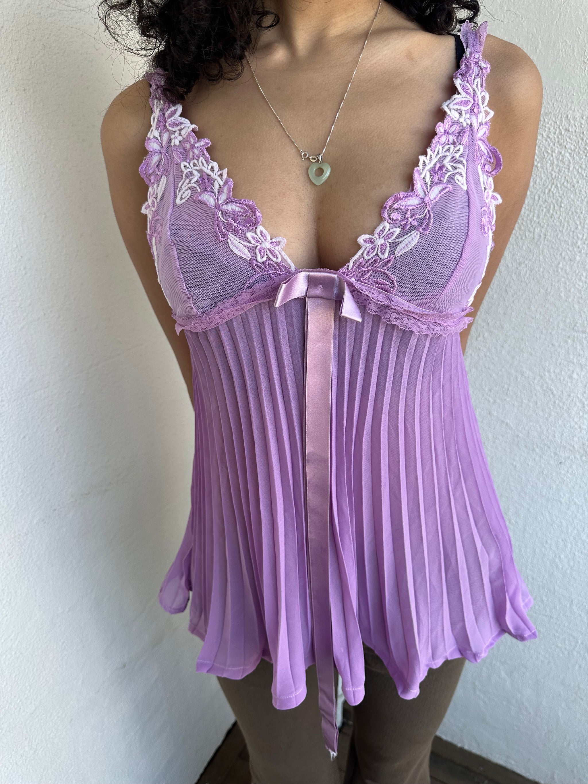 Woman wearing a Y2K 00s Lilac floral embroidered bust cami with a floaty, pleated A-line shape