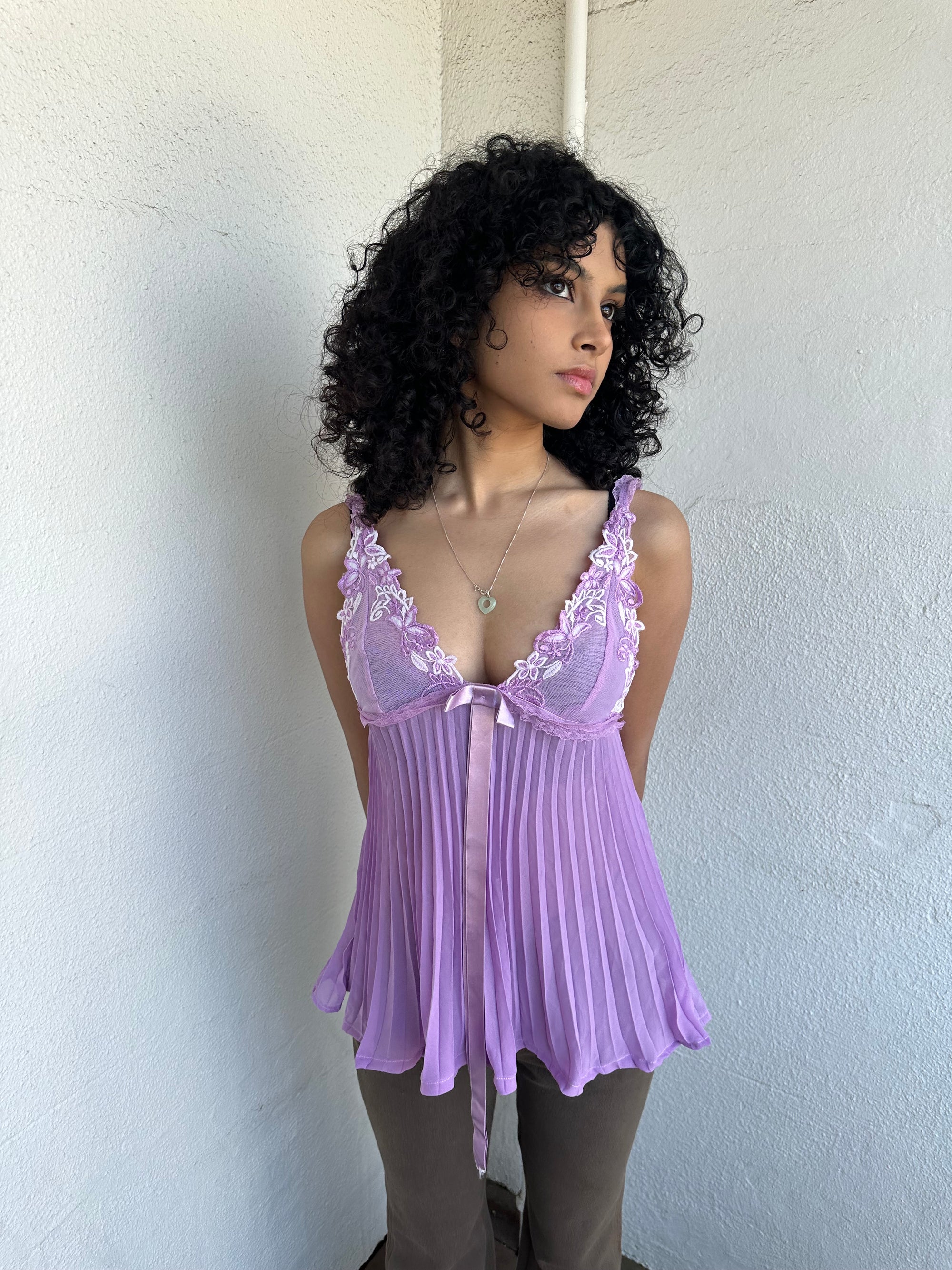 Woman wearing a Y2K 00s Lilac floral embroidered bust cami with a floaty, pleated A-line shape