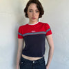 Woman Dressed in Y2K Miss Marines red & navy T-shirt featuring a classic crew neckline with contrasting colour-block panels for a sporty, vintage skater look.