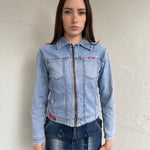 Woman wearing a Y2K 90s Miss Sixty light denim jacket, 3structured fit and stretch denim fabric