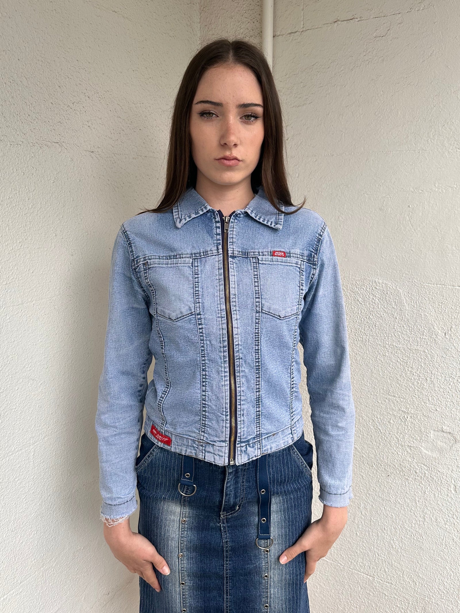 Woman wearing a Y2K 90s Miss Sixty light denim jacket, 3structured fit and stretch denim fabric
