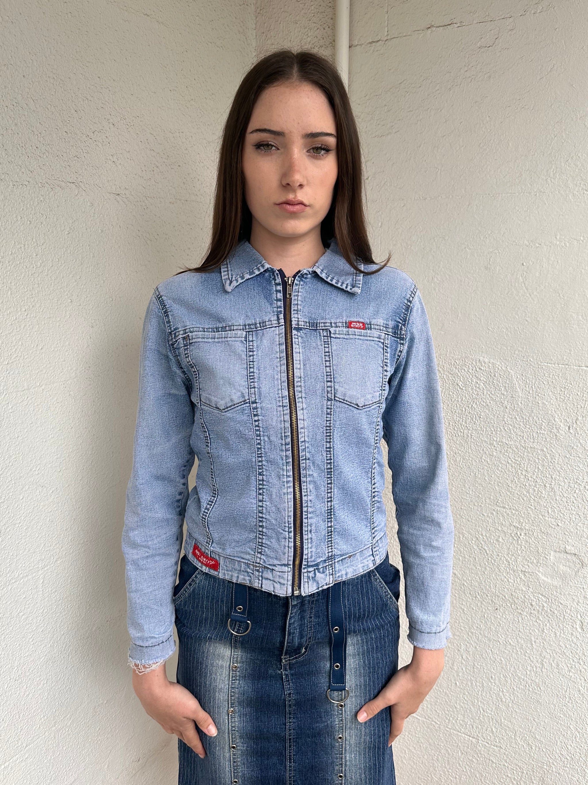 Woman wearing a Y2K 90s Miss Sixty light denim jacket, 3structured fit and stretch denim fabric