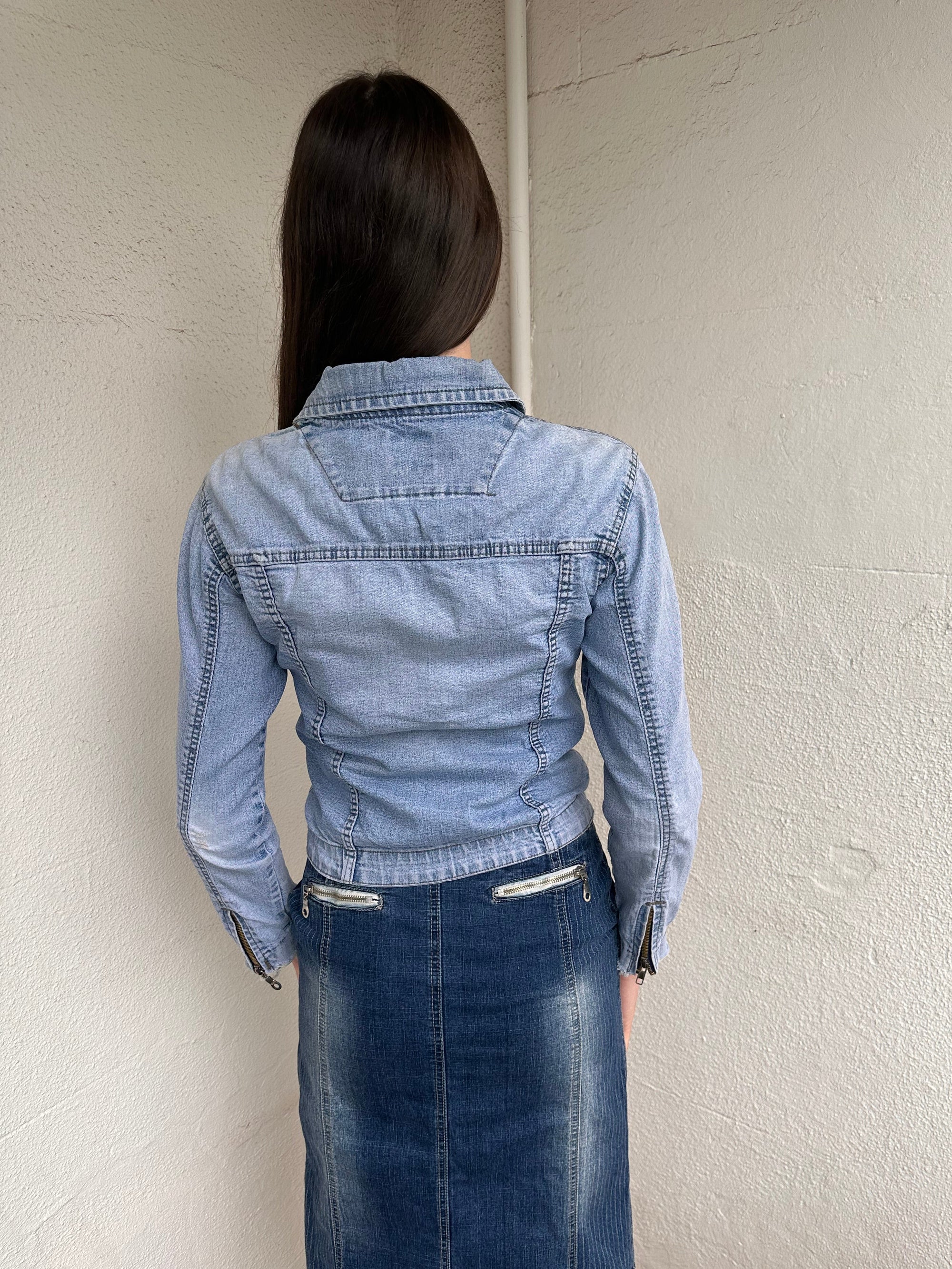 Woman wearing a Y2K 90s Miss Sixty light denim jacket, 3structured fit and stretch denim fabric