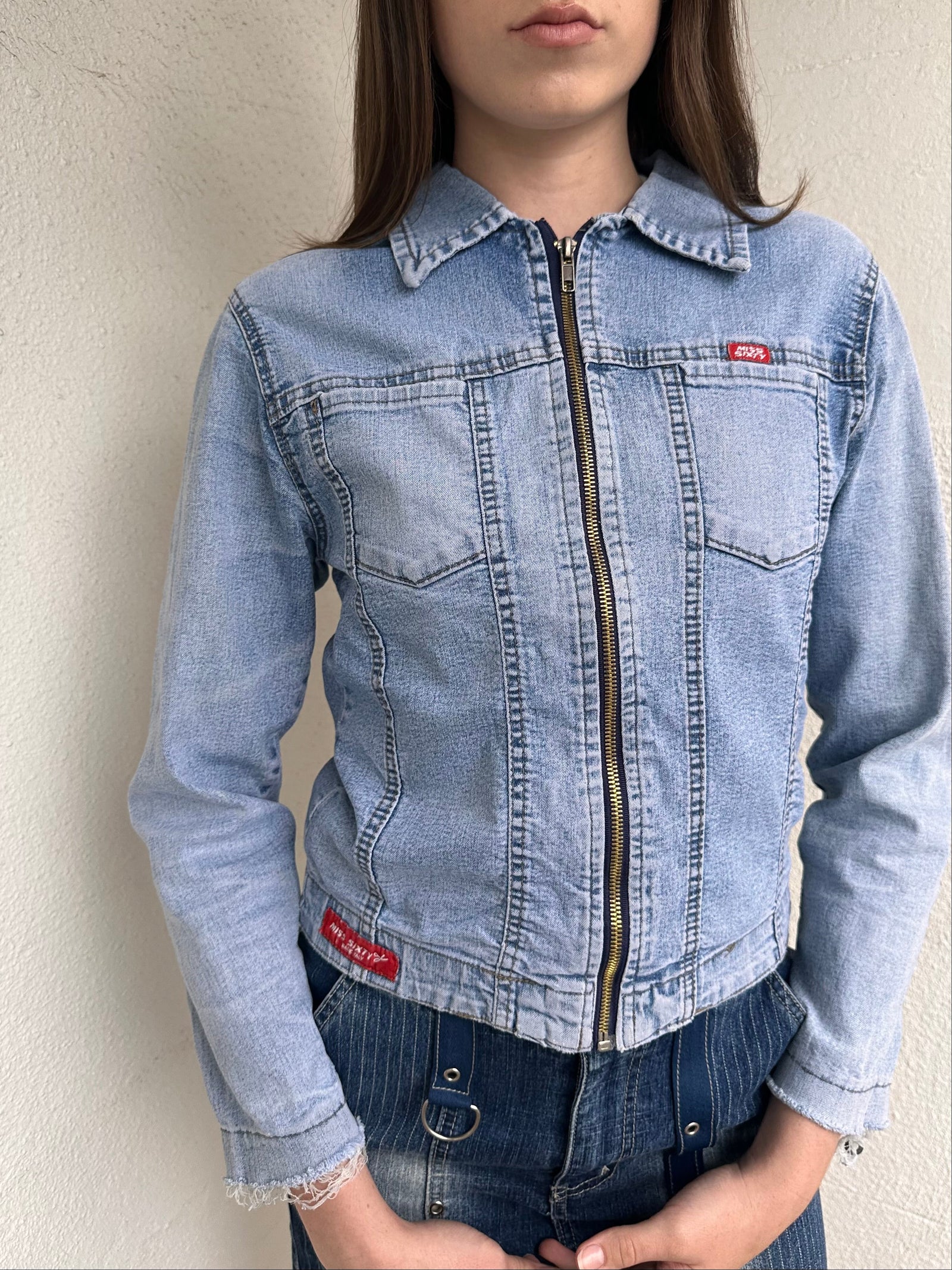 Woman wearing a Y2K 90s Miss Sixty light denim jacket, 3structured fit and stretch denim fabric