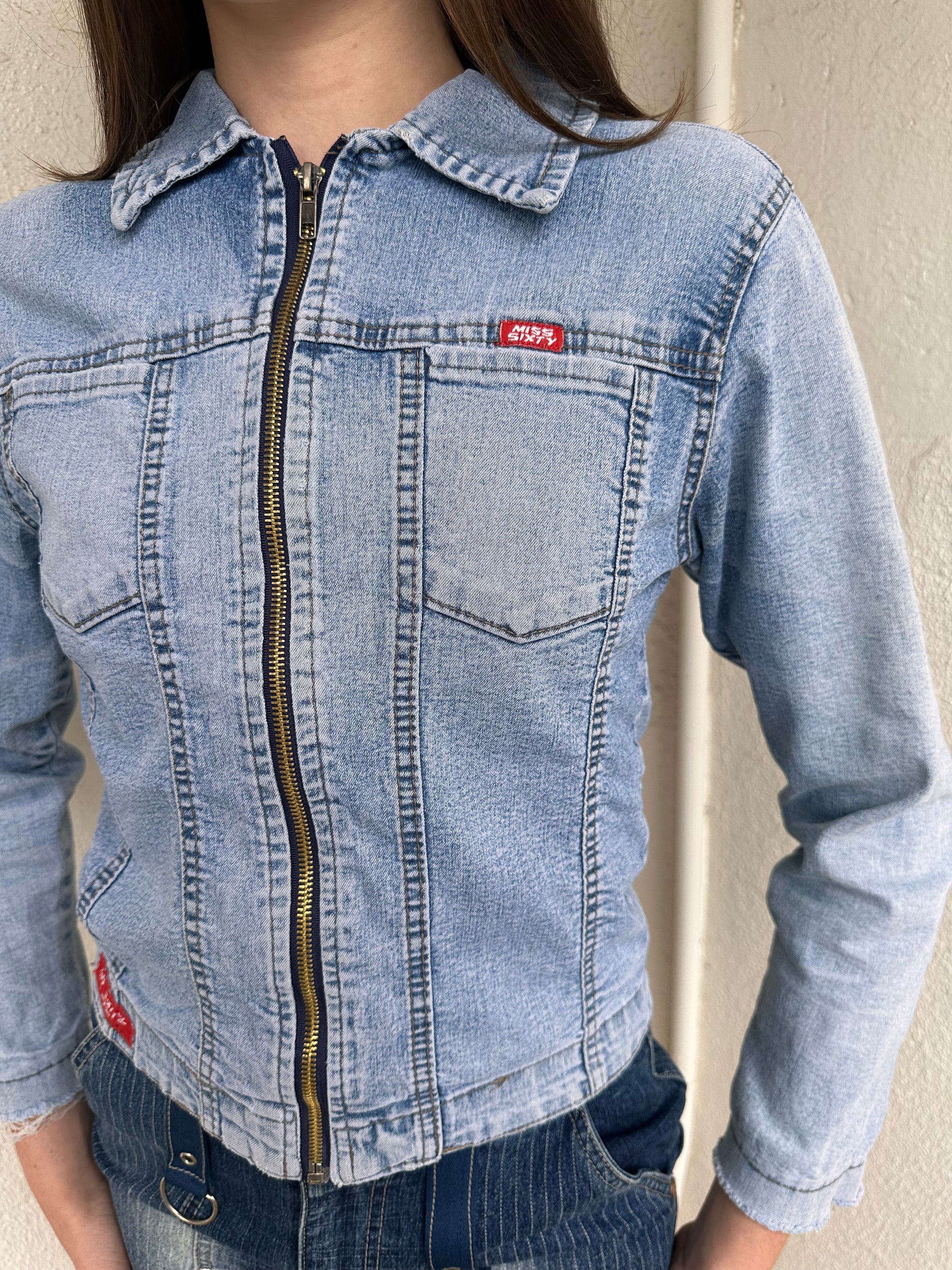 Woman wearing a Y2K 90s Miss Sixty light denim jacket, 3structured fit and stretch denim fabric