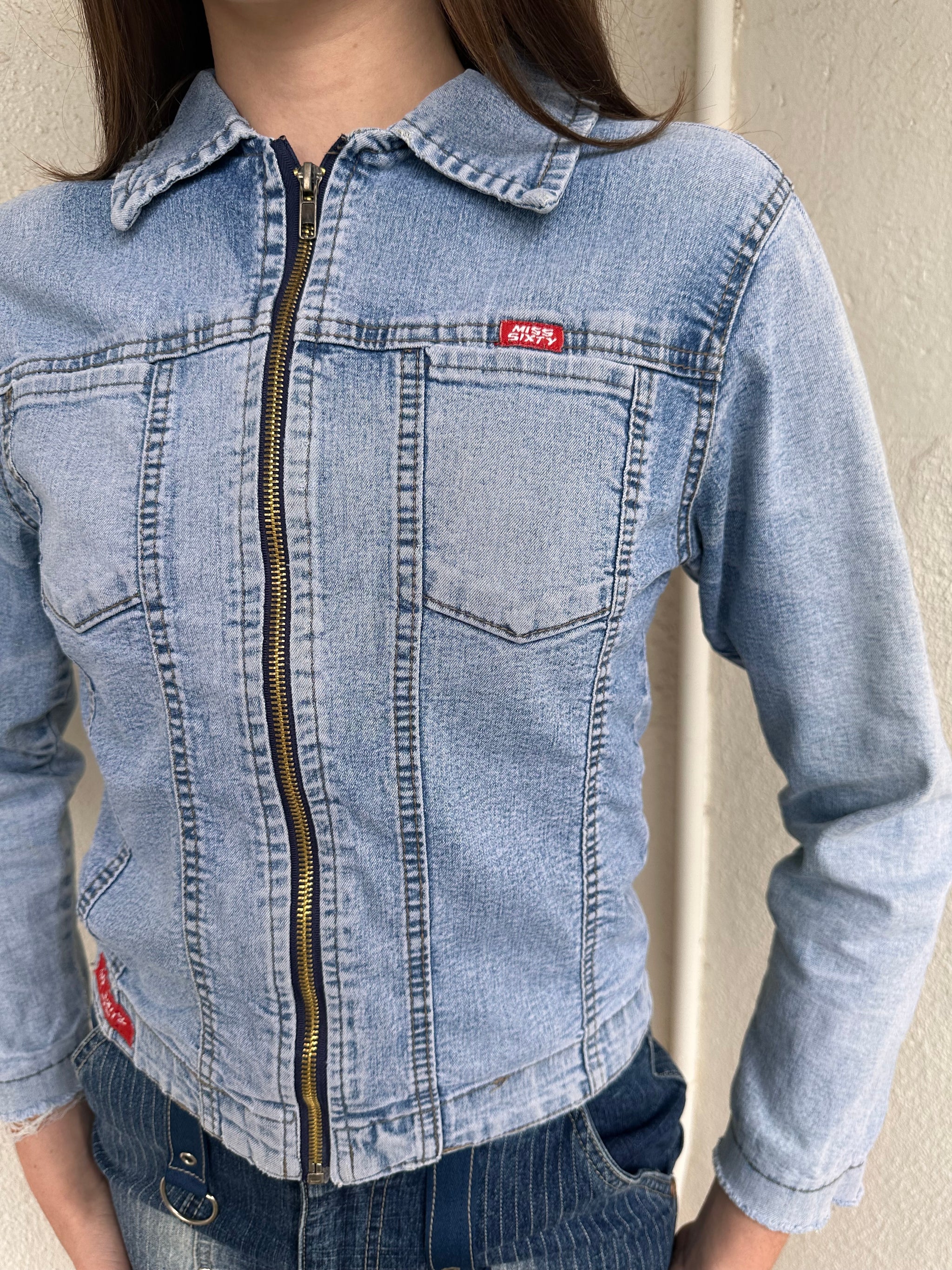 Woman wearing a Y2K 90s Miss Sixty light denim jacket, 3structured fit and stretch denim fabric