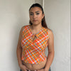 Woman Dressed in Y2K 00s Orange checkered Y2K tank top featuring a bold multi coloured check pattern 