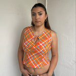 Woman Dressed in Y2K 00s Orange checkered Y2K tank top featuring a bold multi coloured check pattern 