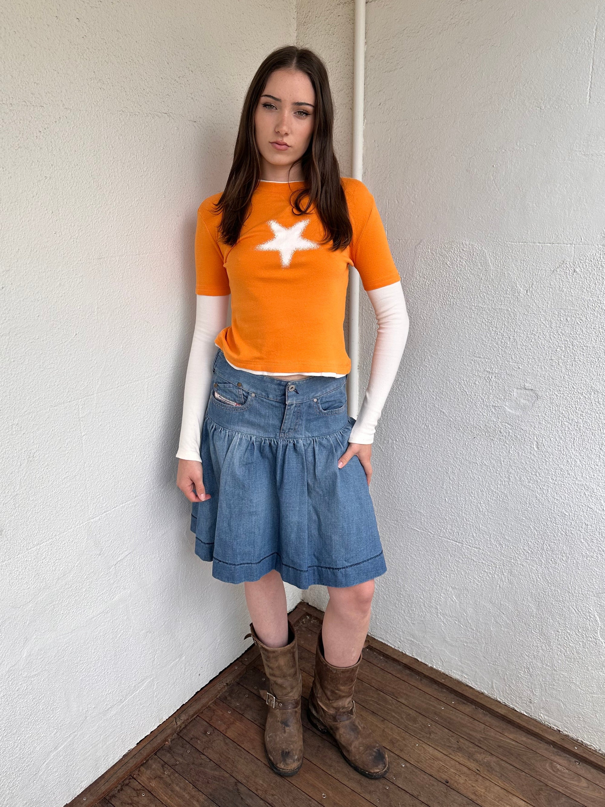 Woman wearing a Y2K 00s Y2K Orange star layered long sleeve top.