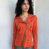 Woman wearing a Y2K 00s Incredible orange two tone jacket channels a modern biker aesthetic