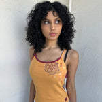 Woman wearing a Y2K 00s Orange & burgundy mandala print layered  cami