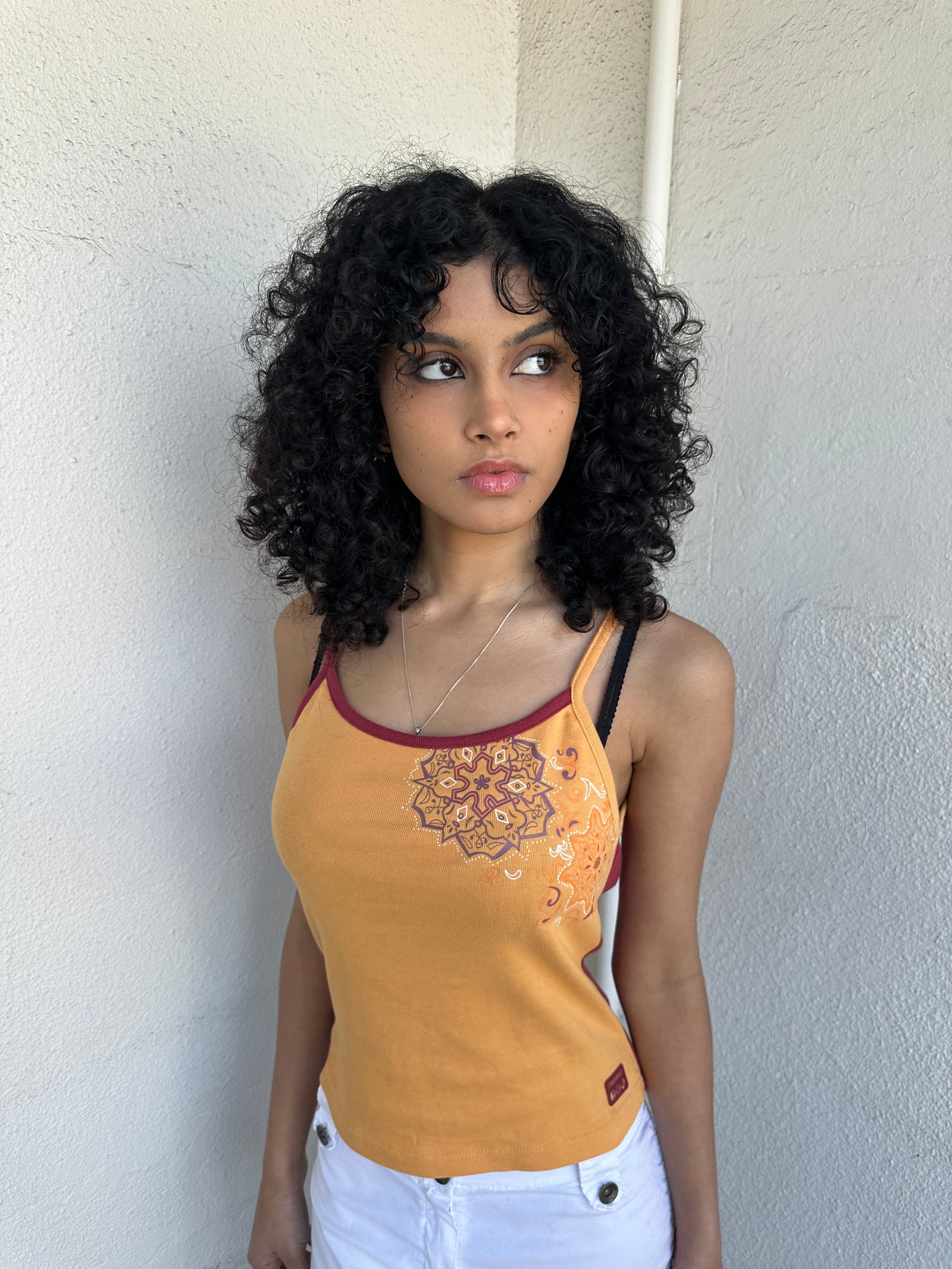 Woman wearing a Y2K 00s Orange & burgundy mandala print layered  cami