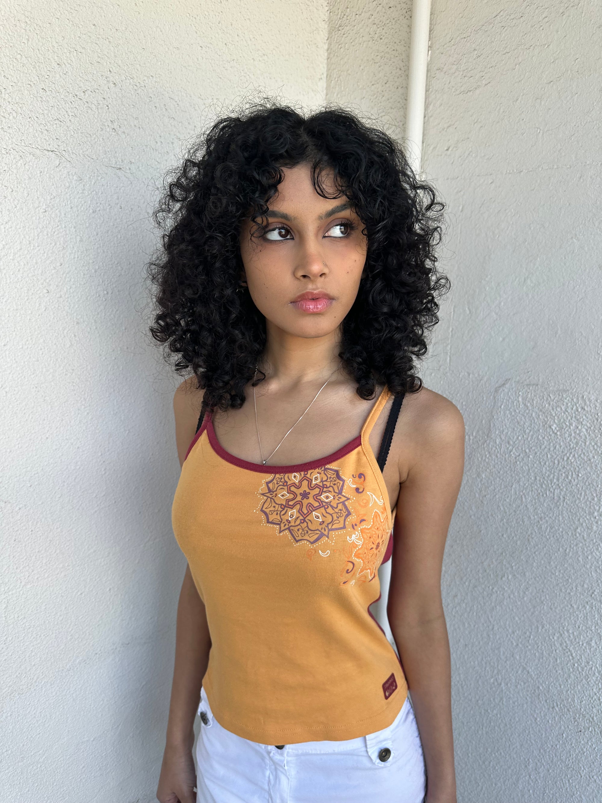 Woman wearing a Y2K 00s Orange & burgundy mandala print layered  cami
